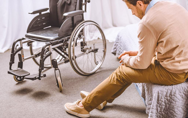 stock photo sad man disability sitting bed