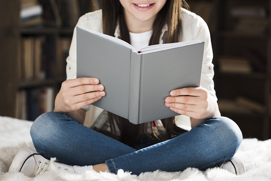 close up young girl reading book 1