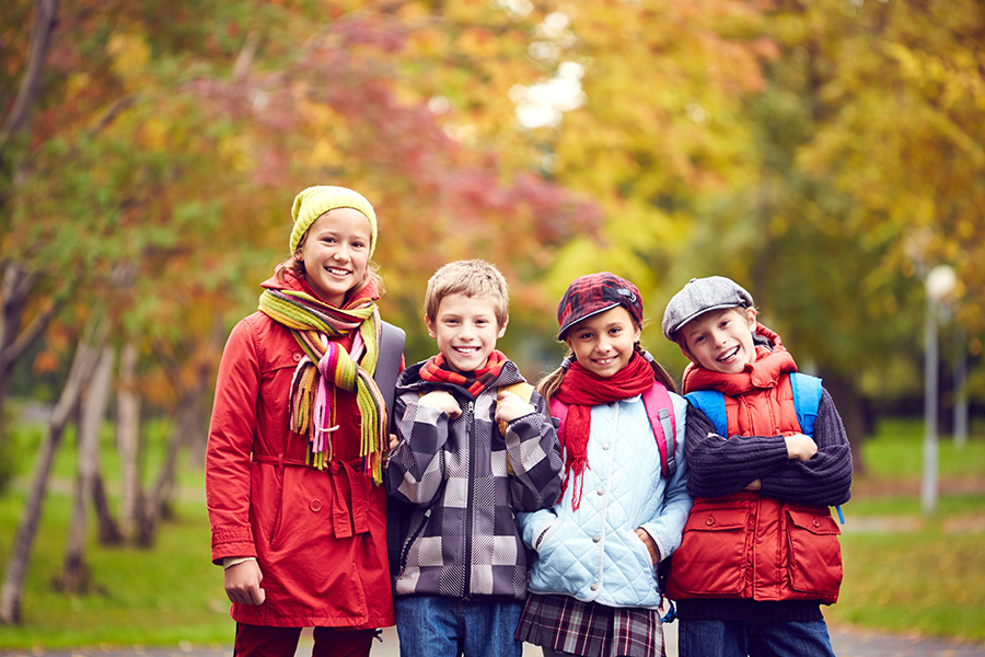 schoolchildren with backpack after school park